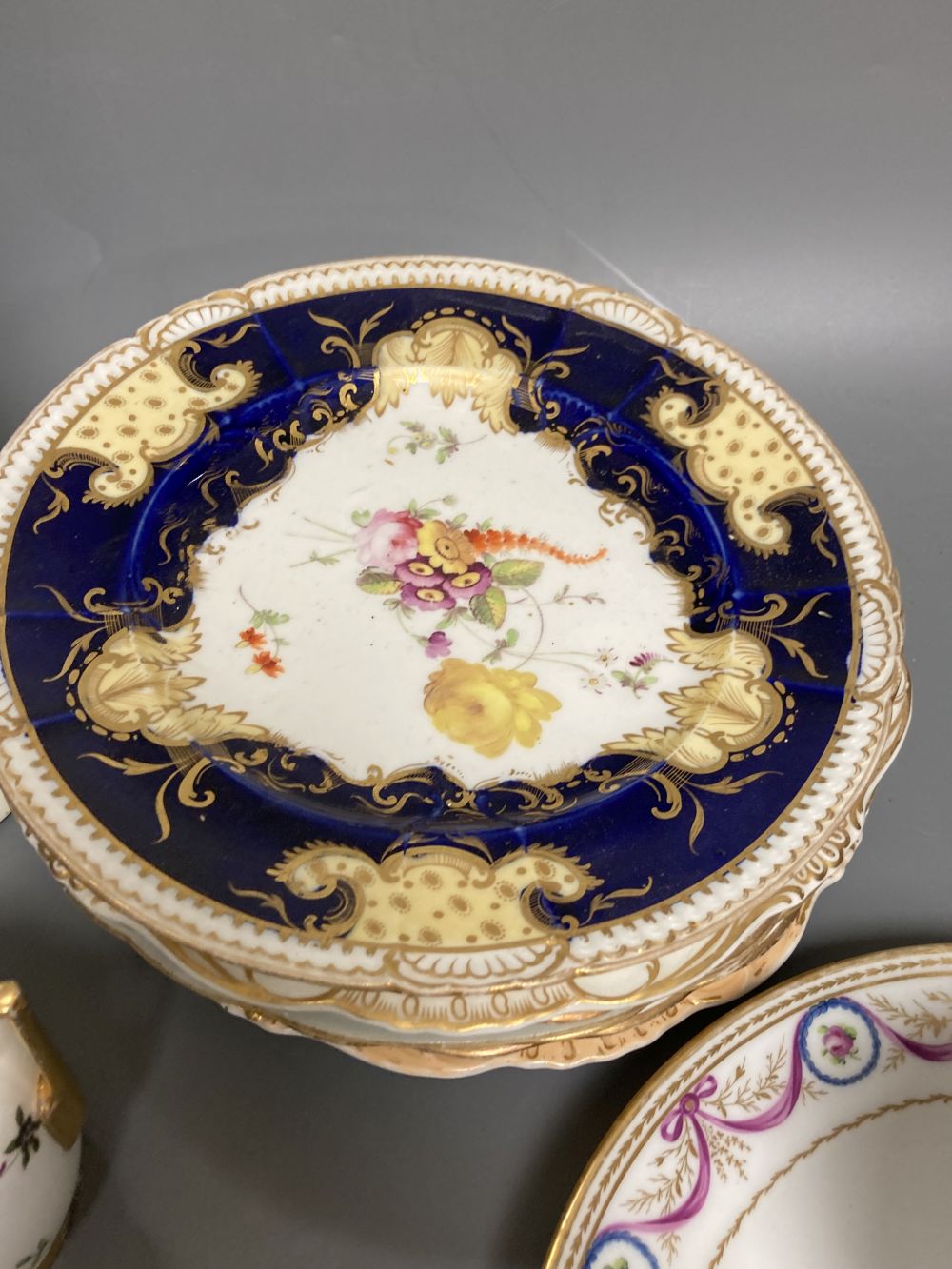 A Worcester Kakiemon vase, c.1765, a 19th century Paris porcelain plate and three tea bowls and 19th century English porcelain plates e